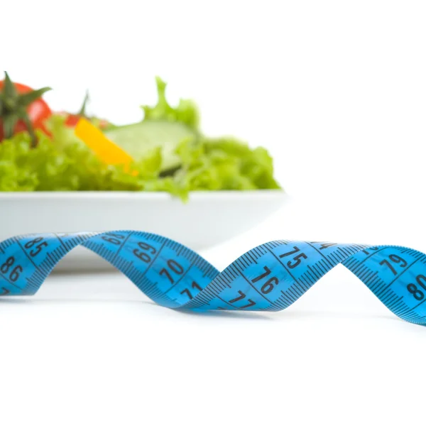 Fresh vegetables and measuring tape — Stock Photo, Image