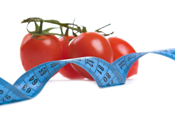Tomatoes and measure tape — Stock Photo, Image