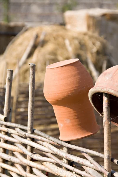 Clay jugs on fence — Stock Photo, Image
