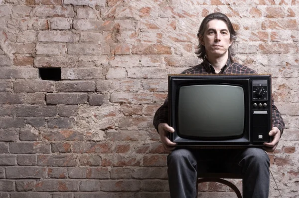 Man holding a retro television — Stock Photo, Image