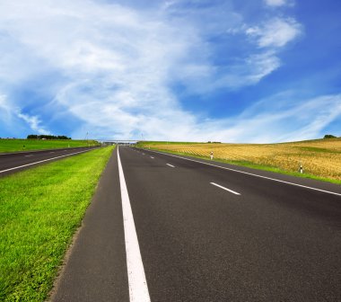 Asphalt road over blue sky clipart