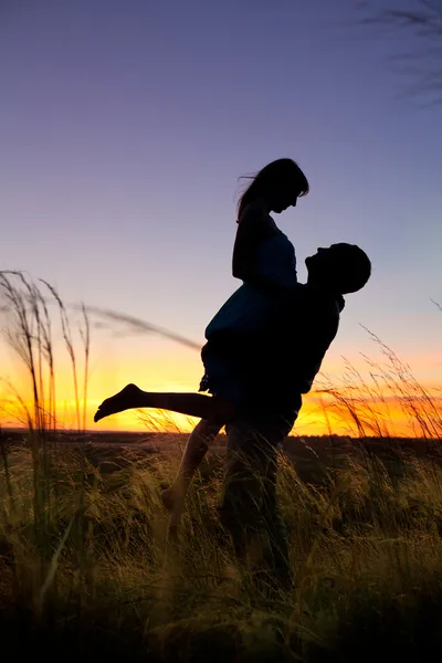 Couple on the sunset background. — Stock Photo, Image