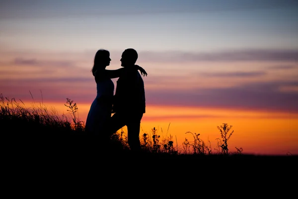 Couple on the sunset background. — Stock Photo, Image