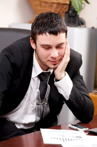 Young pensive businessman working in office — Stock Photo, Image