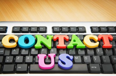 Contact us concept with letters on keyboard