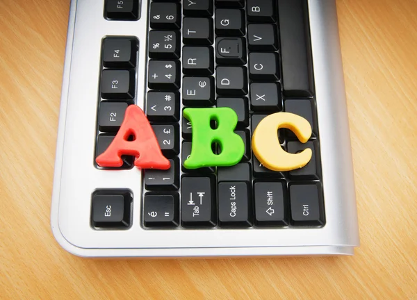 Early education concept with keyboard and letters — Stock Photo, Image