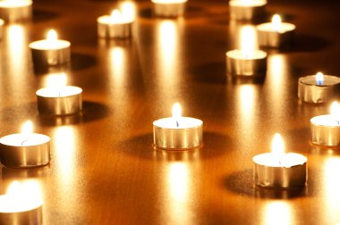 Many burning candles with shallow depth of field clipart