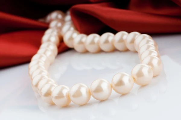 Pearls necklace on satin background — Stock Photo, Image