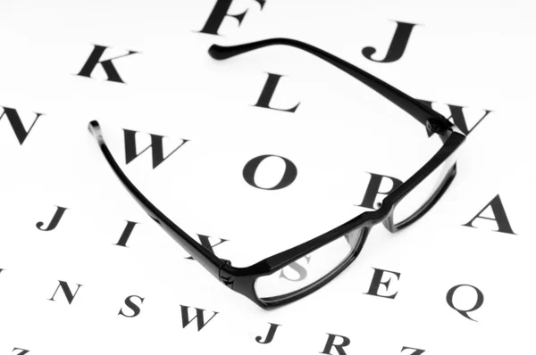 Optical reading glasses on the eyesight table — Stock Photo, Image