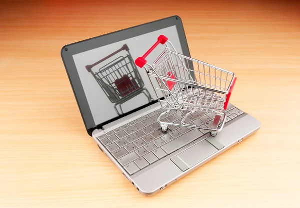 Internet online shopping koncept med dator och vagn — Stockfoto