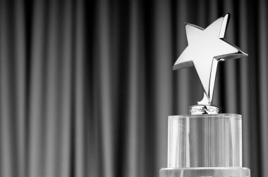 Star award against curtain background clipart