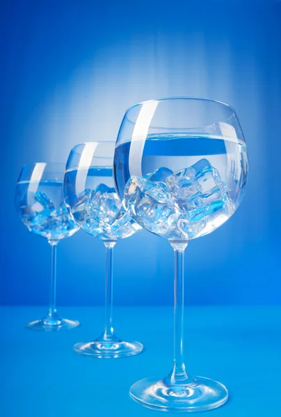 Water in the glass against gradient background — Stock Photo, Image