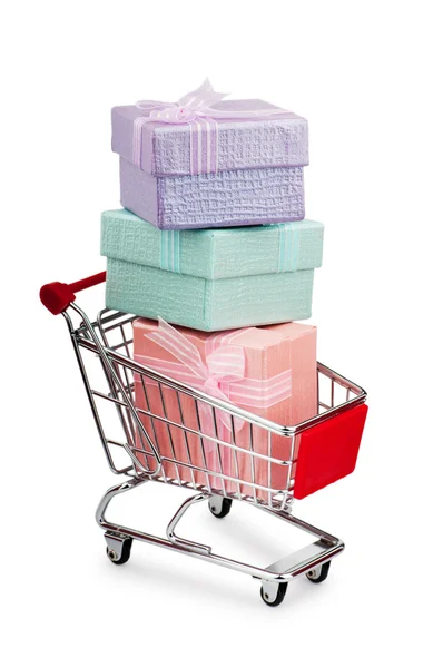 Shopping cart and giftboxes on white — Stock Photo, Image