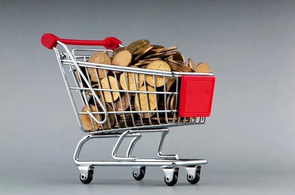 Shopping cart full of coins — Stock Photo, Image