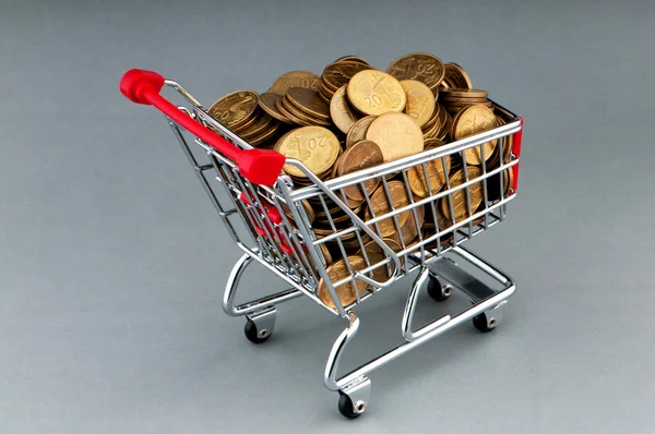 Shopping cart full of coins — Stock Photo, Image