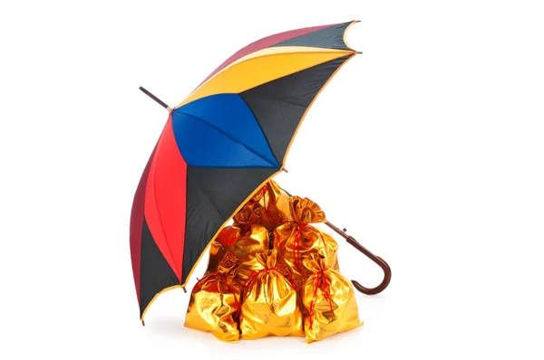 Golden sacks under protection of umbrella — Stock Photo, Image