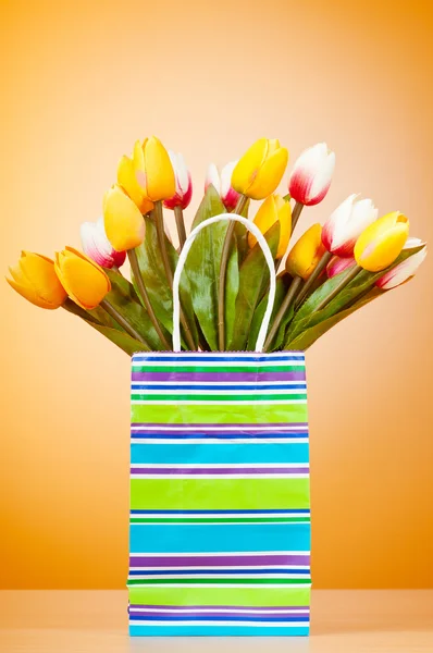 Tulipanes en la bolsa contra el fondo degradado —  Fotos de Stock
