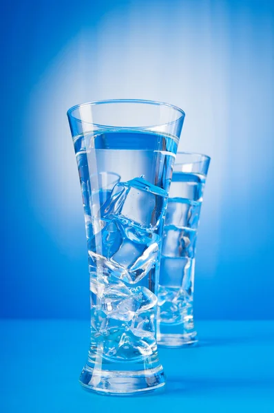 Agua en el vaso contra el fondo degradado — Foto de Stock