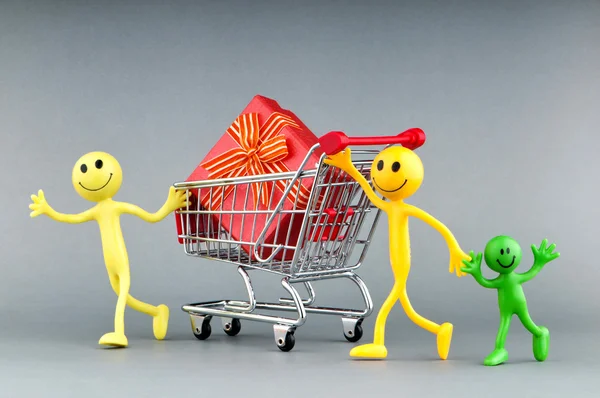 Smileys with gift box in the shopping cart Stock Image