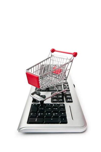 Internet online shopping concept with computer and cart — Stock Photo, Image