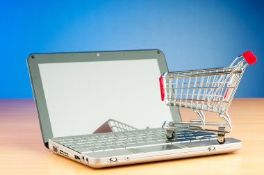 Internet online shopping concept with computer and cart clipart