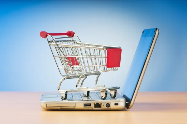 Internet online shopping concept with computer and cart Stock Photo