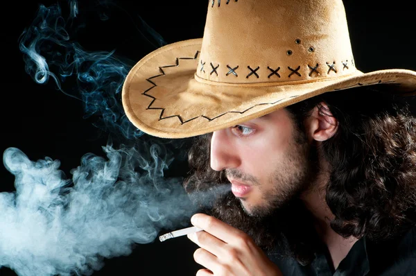 Man in cowbow hat smoking — Stock Photo, Image