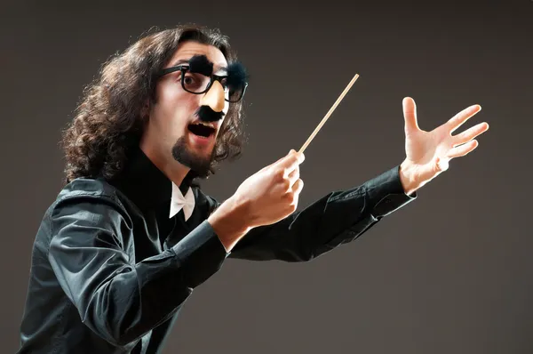 Funny conductor against dark background — Stock Photo, Image
