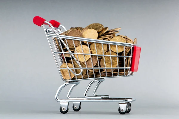 Shopping cart full of coins — Stock Photo, Image
