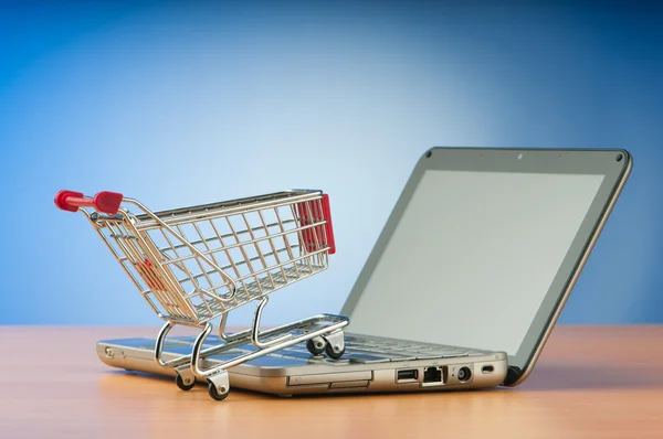 Концепция интернет-покупок с компьютером и корзиной Стоковая Картинка