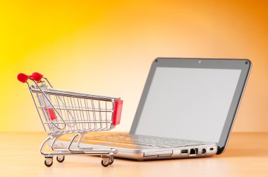 Internet online shopping concept with computer and cart clipart