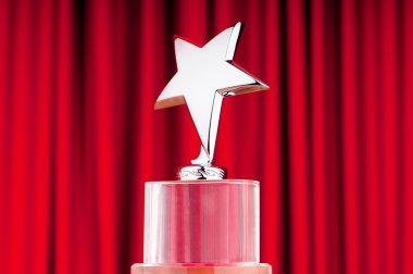 Star award against curtain background clipart