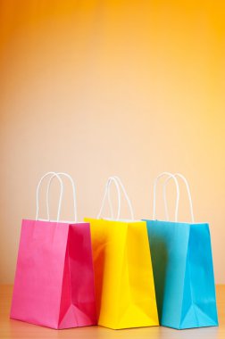 Shopping bags against gradient background clipart