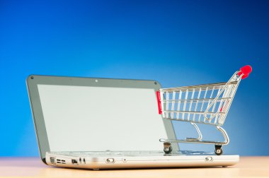 Internet online shopping concept with computer and cart clipart