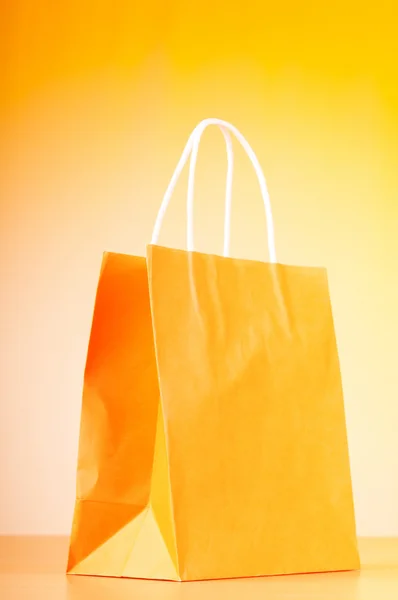 Shopping bags against gradient background — Stock Photo, Image
