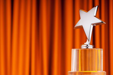 Star award against curtain background clipart