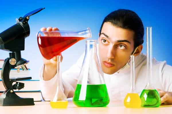 Químico en el laboratorio experimentando con soluciones — Foto de Stock