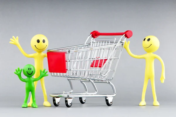 Happy family with shopping cart Stock Picture