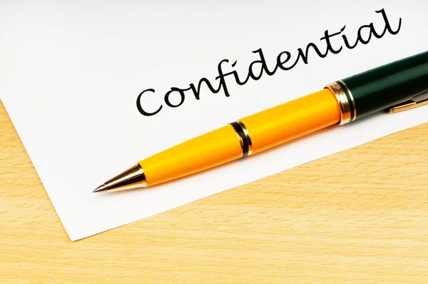 stock image Pen and confidential message on white