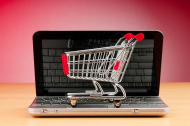 Internet online shopping concept with computer and cart clipart