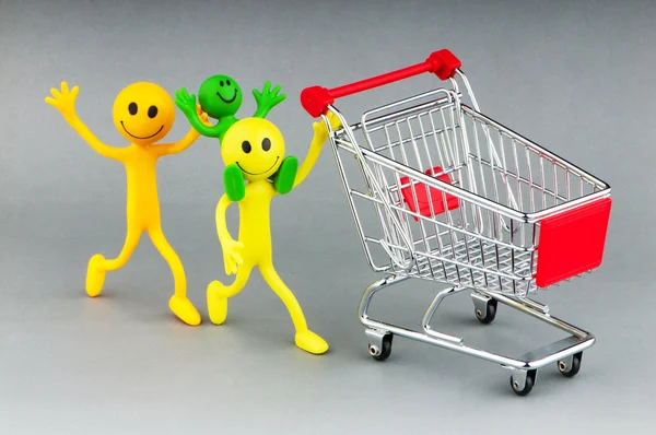 Shopping cart and happy smilies — Stock Photo, Image