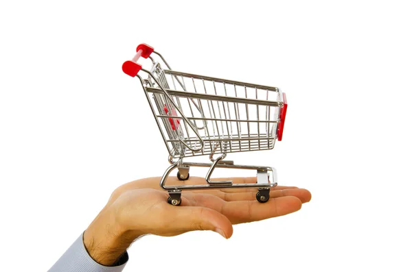 Hand holding shopping cart on white — Stok fotoğraf
