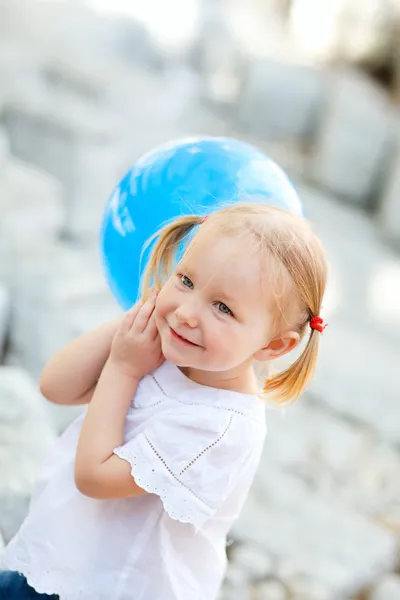Little girl with blue balloon — Stock Photo, Image