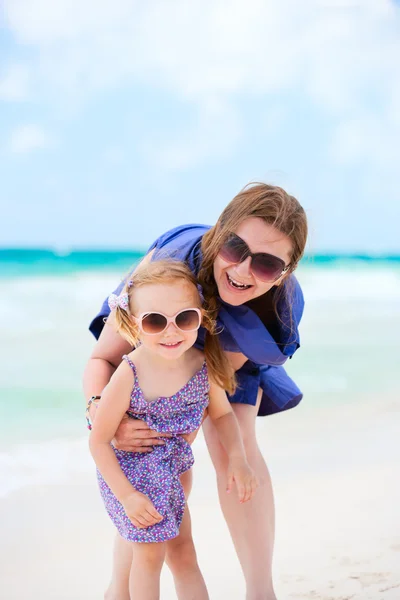 Happy mother and daughter at beach Stock Photo