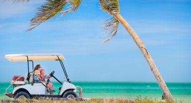 Golf cart at tropical beach clipart