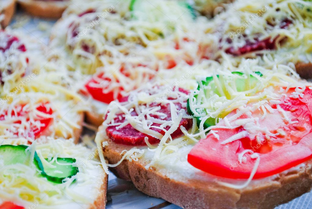 Snack sliced bread with fresh vegetables, mayonnaise and cheese