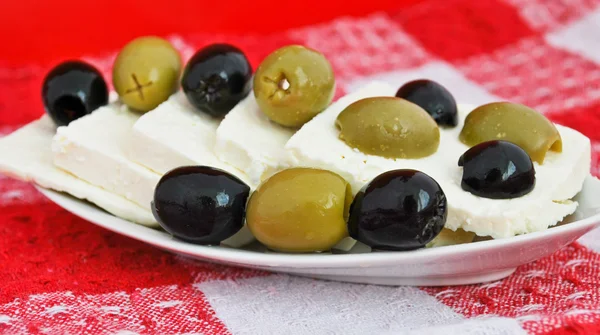 stock image Still life of brynza cheese and olives on a kitchen towel