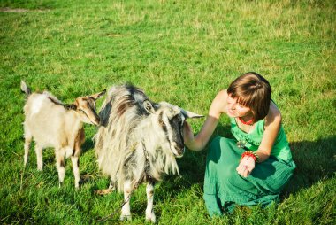 A cowgirl with goats clipart