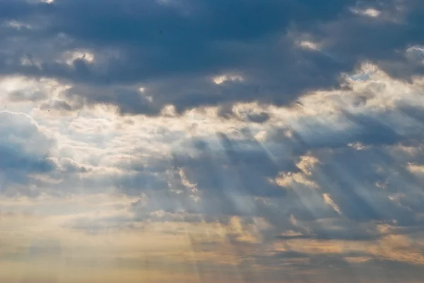 stock image Light rays shine through the dark clouds