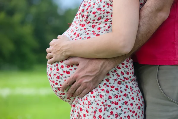 Husband hands on pregnant woman belly — Stock Photo, Image